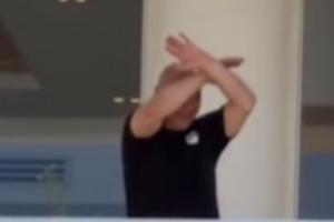 埃及主帅哈桑回国后挥手向现场球迷致意,随后再次做出交叉手势配图